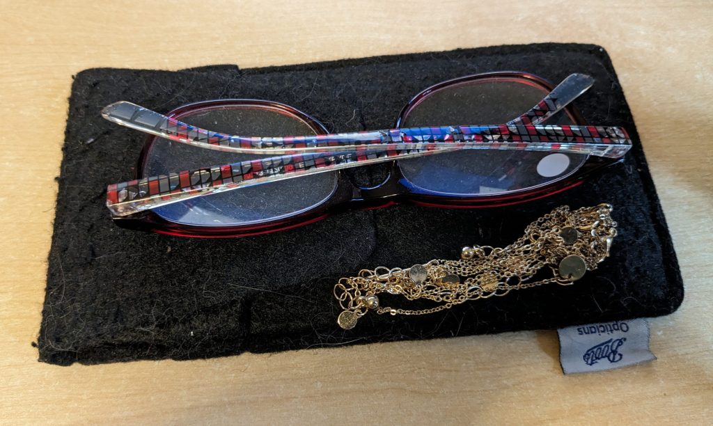 Lost glasses, fabric case and gold chain